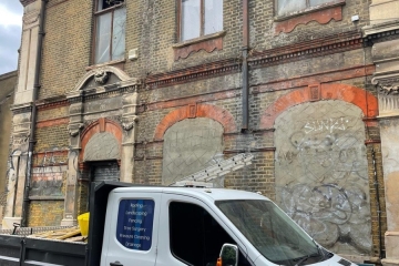 An old building that has had graffiti removed from the walls in Croydon