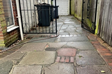 A dirty driveway that needs pressure washing