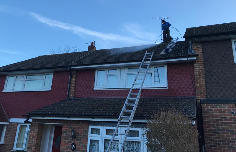 A roof being pressure washed in Croydon